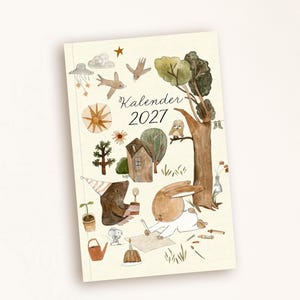 May include: A 2027 calendar with a cream-colored background featuring watercolor illustrations of a brown bear in a party hat, a rabbit drawing, a small mouse, a house, trees, birds, and stars. The text Kalender 2027 is printed in the center.