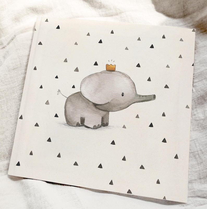 May include: A watercolor illustration of a gray elephant wearing a gold crown. The elephant is standing on a white background with black triangle shapes.