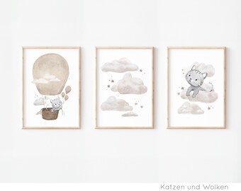 May include: Three framed prints with a watercolor style illustration of a cat in a hot air balloon, a cat on a cloud, and clouds with stars. The text "Katzen und Wolken" is at the bottom of the image.
