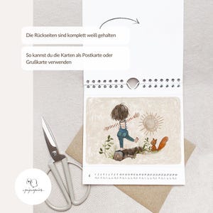 May include: A calendar with a whimsical illustration of a child, a squirrel, and a sun. The calendar has a white spiral binding and the text "Die R&uuml;ckseiten sind komplett wei&szlig; gehalten" and "So kannst du die Karten als Postkarte oder Gru&szlig;karte verwenden".