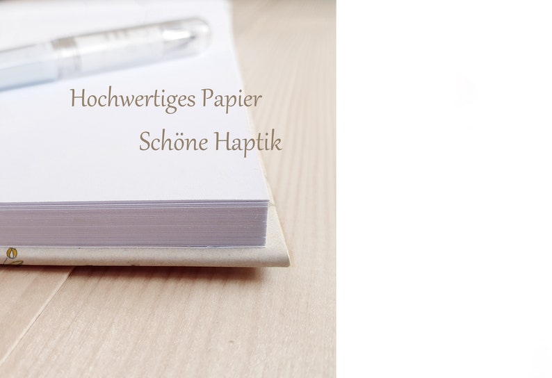 May include: Close-up of the spine of a bound book with white pages. The text on the spine reads "Hochwertiges Papier Sch&ouml;ne Haptik".