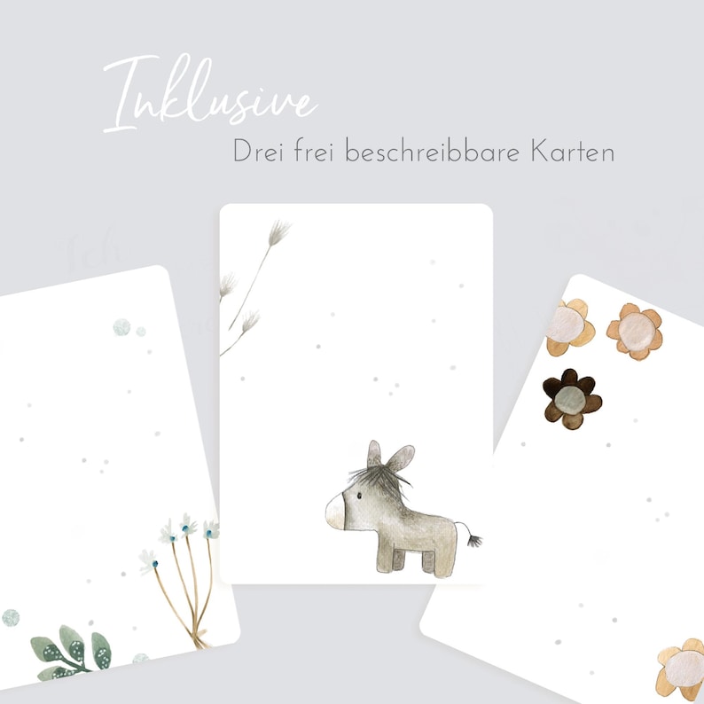 May include: Three blank cards with watercolor illustrations. One card features a donkey, another has a floral design, and the third has a simple flower design. The text "Inklusive" and "Drei frei beschreibbare Karten" is printed on the cards.