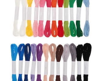May include: A set of 24 embroidery floss spools in a variety of colors, including white, yellow, pink, orange, red, green, blue, purple, brown, and black.