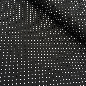 May include: Black fabric with a white polka dot pattern. The fabric is folded in half, showing the pattern on both sides.