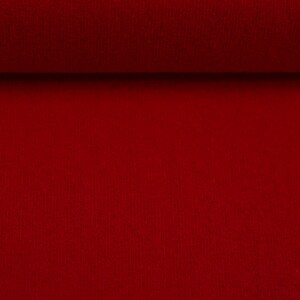 Puede incluir: Primer plano de una tela roja con una superficie texturizada.