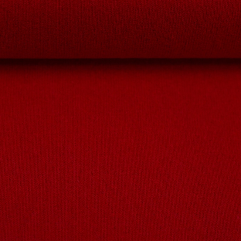 Puede incluir: Primer plano de una tela roja con una superficie texturizada.