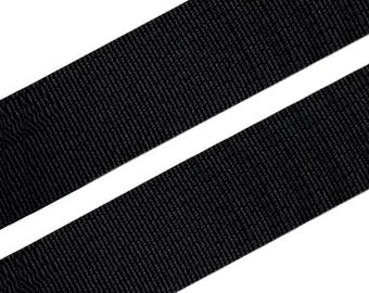 May include: Black woven nylon webbing strap. The strap is flat and has a smooth texture.