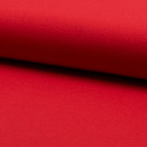 Può includere: Primo piano di un tessuto rosso vivo con una texture morbida e soffice.
