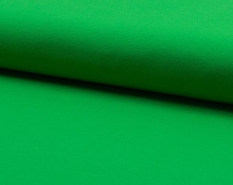 Pode incluir: Um close-up de um tecido verde brilhante. O tecido tem uma textura lisa e uniforme.