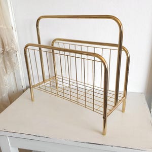 vintage magazine rack, old newspaper rack, record rack, gold, aluminum, string, modern, magazines
