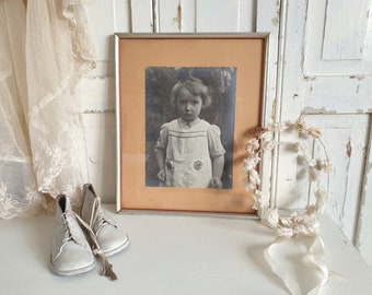 Framing antique shop baby clothes