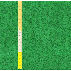 May include: Green fabric with a repeating pattern of black swirls. A ruler is visible on the right side of the image.