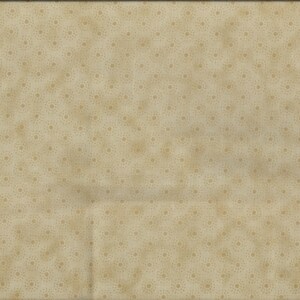 May include: A beige fabric with a subtle pattern of small, light brown dots. The fabric has a slightly textured surface.