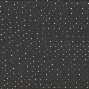 Op de afbeelding: Donkergrijze stof met een herhalend patroon van kleine witte stippen. Een gele en witte liniaal staat rechts van de stof en toont de afmetingen in centimeters.