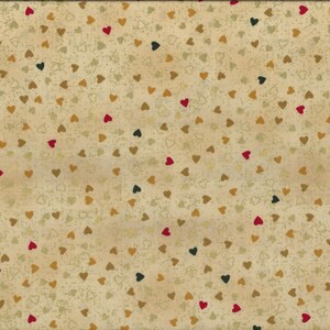 May include: A fabric with a beige background scattered with small hearts in red, gold, and dark green. The fabric has a textured appearance and a yellow ruler is on the right side, showing measurements up to 20 inches.