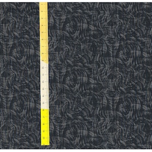 Pode incluir: Um tecido azul escuro com um padrão de redemoinho branco. O tecido tem uma superfície texturizada, semelhante ao veludo cotelê.