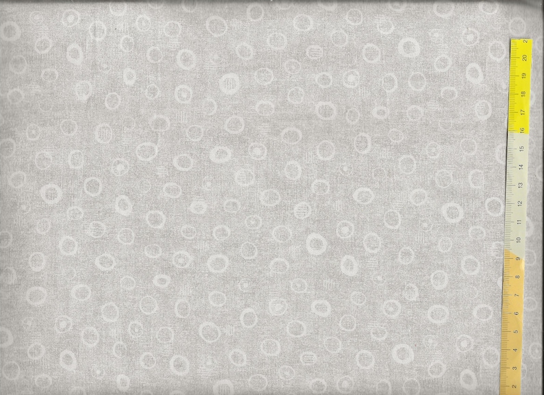 May include: A grey fabric with a white circle pattern. The fabric is textured and has a subtle linen look.