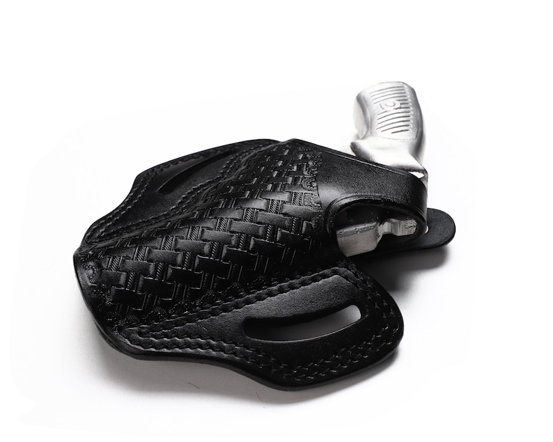 May include: A black leather holster with a woven pattern for a silver handgun.