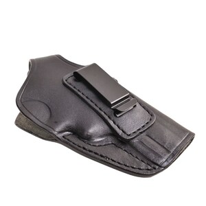May include: Black leather holster with a metal clip. The holster is designed to hold a handgun. The leather is stitched around the edges. The clip is attached to the top of the holster.