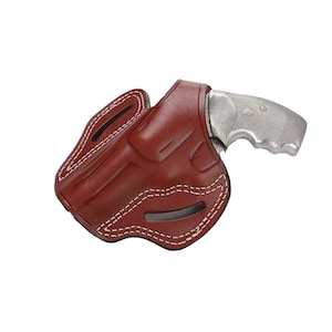 May include: A brown leather holster with white stitching for a revolver. The holster is designed to be worn on the belt.