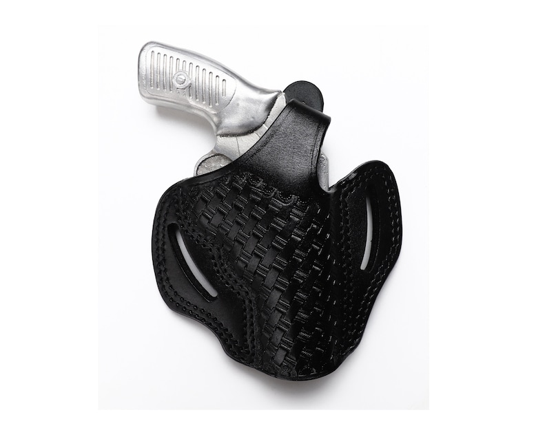 May include: A black leather holster with a woven pattern for a silver handgun.