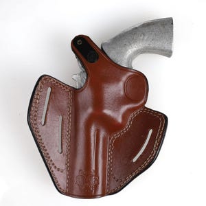 Colt Python 4.25 inch leather holster with 3-slot belt loop for vertical or angled carry, thumb break security, premium brown cowhide.