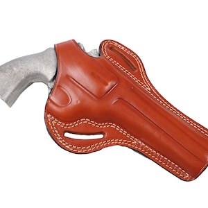 May include: A brown leather holster with white stitching, designed for a revolver. The holster is shaped to fit the firearm and has a belt loop. The revolver is silver.