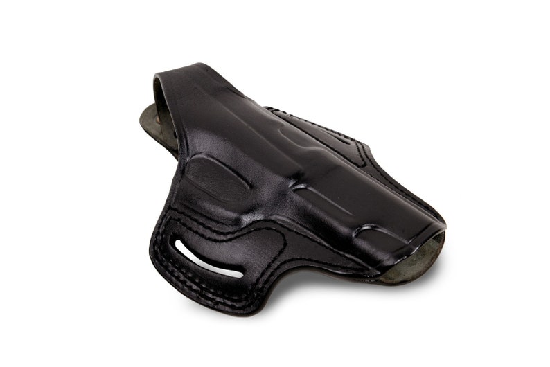 May include: A black leather holster for a handgun. The holster has a belt loop and a snap closure.
