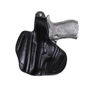 Handmade Black Left Hand leather OWB pancake holster by Pusat Holster, precision-molded for Beretta 84, 84BB, 84F, and 84FS Cheetah .380 ACP models. The image highlights the 100% premium genuine leather texture, hand-polished edges, and heavy-duty stitching on a white background. Features a secure thumb break with durable brass snaps and 304 stainless steel hardware. Designed for a perfect, rattle-free fit, offering a blend of classic style and tactical durability for daily carry.