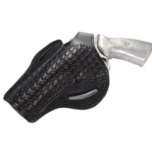 May include: A black leather holster with a woven pattern for a silver handgun.