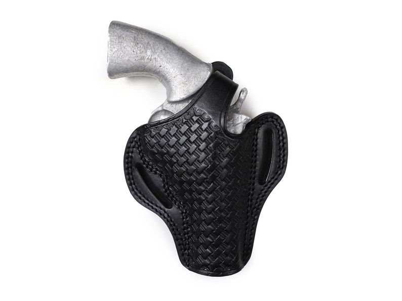 May include: A black leather holster with a woven pattern, designed to hold a silver revolver.