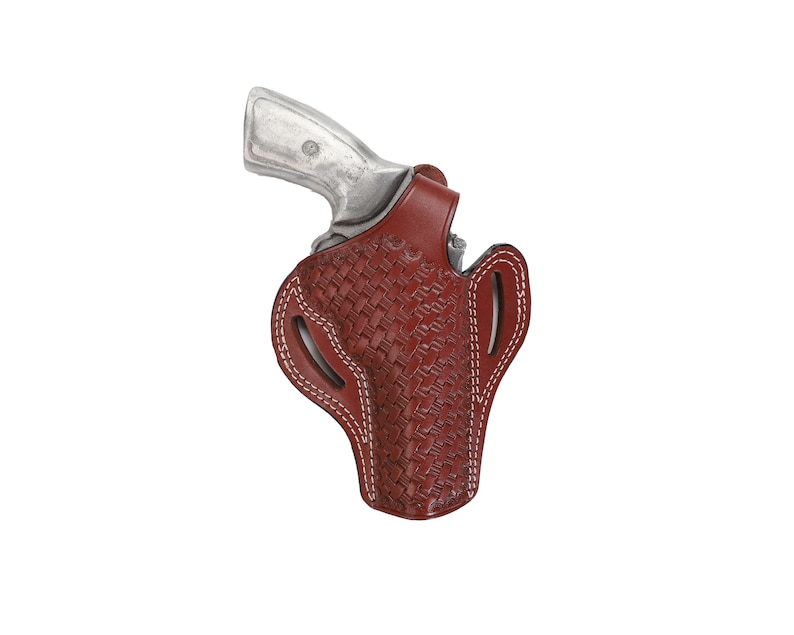 May include: A brown leather holster with a woven pattern and white stitching. The holster is designed to hold a revolver.