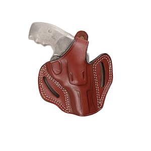 May include: A brown leather holster with white stitching for a handgun. The holster has a belt loop and a snap closure.