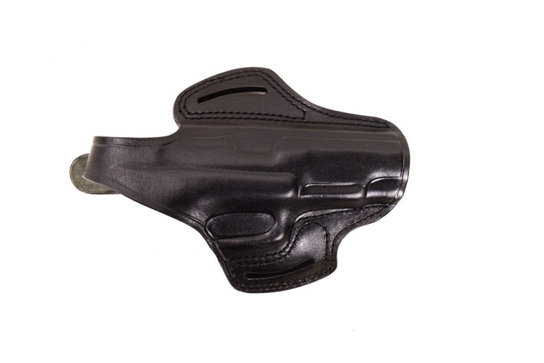 May include: A black leather holster for a handgun. The holster has a belt loop and a snap closure.
