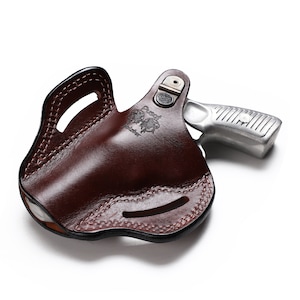 May include: A brown leather holster with a silver revolver inside. The holster has a belt loop and a snap closure. The revolver has a black grip and a silver barrel.