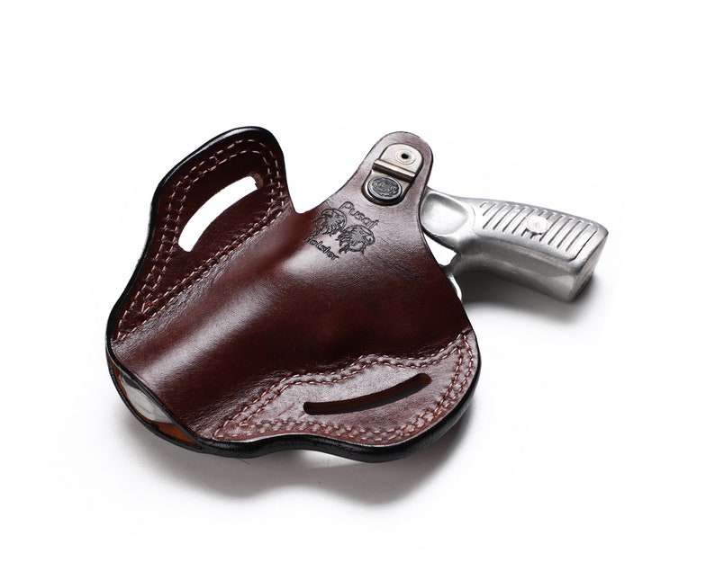 May include: A brown leather holster with a silver revolver inside. The holster has a belt loop and a snap closure. The revolver has a black grip and a silver barrel.