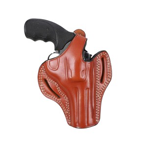 May include: A brown leather holster with white stitching for a handgun.