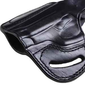 Handmade Black Left Hand leather OWB pancake holster by Pusat Holster, precision-molded for Beretta 84, 84BB, 84F, and 84FS Cheetah .380 ACP models. The image highlights the 100% premium genuine leather texture, hand-polished edges, and heavy-duty stitching on a white background. Features a secure thumb break with durable brass snaps and 304 stainless steel hardware. Designed for a perfect, rattle-free fit, offering a blend of classic style and tactical durability for daily carry.