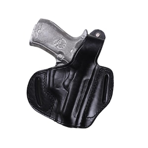 Handmade Black Right Hand leather OWB pancake holster by Pusat Holster, precision-molded for Beretta 84, 84BB, 84F, and 84FS Cheetah .380 ACP models. The image highlights the 100% premium genuine leather texture, hand-polished edges, and heavy-duty stitching on a white background. Features a secure thumb break with durable brass snaps and 304 stainless steel hardware. Designed for a perfect, rattle-free fit, offering a blend of classic style and tactical durability for daily carry.