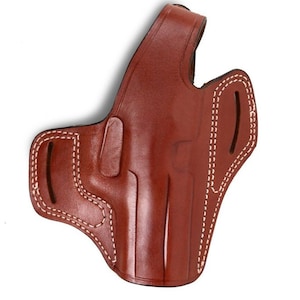 May include: A brown leather holster with white stitching. The holster has a molded design and a belt loop. The stitching is visible along the edges and around the belt loop. The leather has a glossy finish.