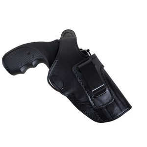 May include: Black leather holster with a black revolver. The holster features a belt clip and is designed to securely hold the firearm. The revolver has a textured grip for a secure hold.