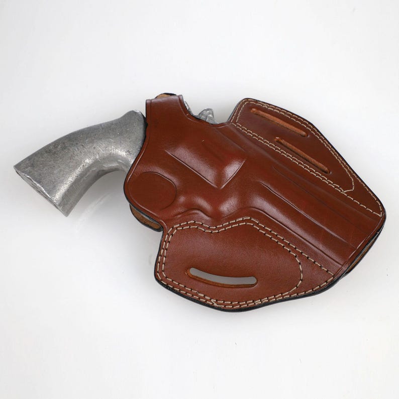 Colt Python 4.25 inch leather holster with 3-slot belt loop for vertical or angled carry, thumb break security, premium brown cowhide.