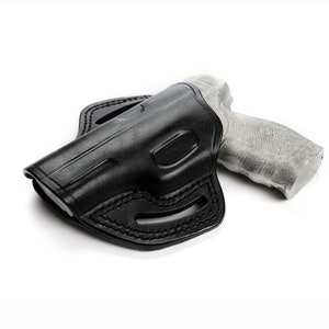 Puede incluir: Una funda de cuero negra para una pistola. La funda tiene un bucle para el cintur&oacute;n y una protecci&oacute;n para el gatillo.