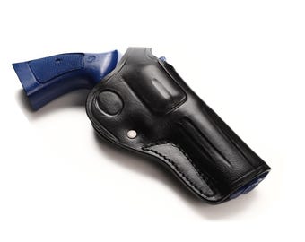 May include: A black leather holster with a blue handgun grip. The holster is designed to fit the shape of the gun, with a curved design and a snap closure. The background is white.