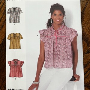 May include: Simplicity sewing pattern S9546. The pattern includes designs for tops with various sleeve styles and necklines. The size range is U.S. 4-16. The pattern is easy-to-sew and designed and printed in the USA.