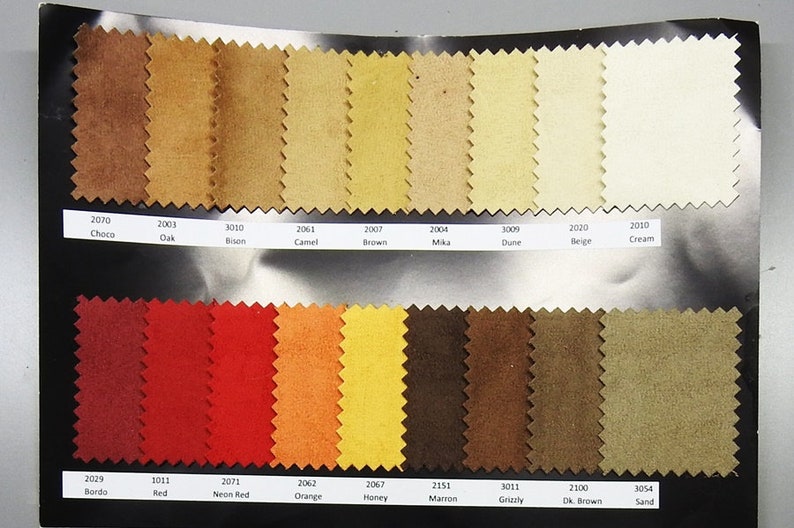 May include: A color chart of fabric swatches in various shades of brown, red, orange, yellow, and beige. The swatches are labeled with numbers and names, such as Choco, Oak, Bison, Camel, Brown, Mika, Dune, Beige, Cream, Bordo, Red, Neon Red, Orange, Honey, Marron, Grizzly, Dk. Brown, and Sand.