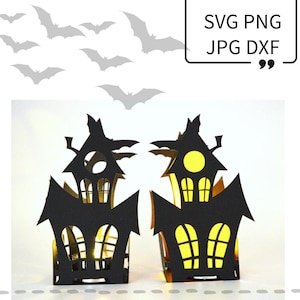 May include: Two black papercraft haunted houses with yellow windows and a lit candle inside. The houses are on a white background with gray bats flying above.