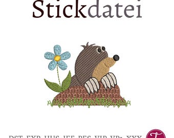 Può includere: Disegno ricamato di una talpa marrone che spunta da un buco con un fiore blu. Il testo "Stickdatei" è sopra l'immagine. Il testo "DST, EXP, HUS, JEF, PES, VIP, VP3, XXX" è sotto l'immagine.