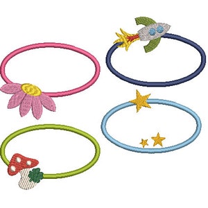 May include: Four colorful hair ties with different charms. A pink hair tie with a pink flower charm, a green hair tie with a red and white mushroom charm, a blue hair tie with a yellow star charm, and a navy blue hair tie with a rocket ship charm.
