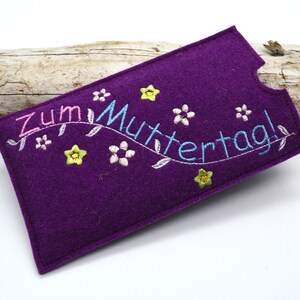 May include: Purple felt phone case with embroidered flowers and the text "Zum Muttertag!" in pink, blue, and yellow thread.